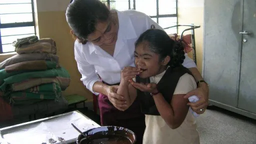 Student tasting the chocolate covered biscuit