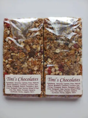 Two Tini's Chocolates granola bars, clear-wrapped with ingredient labels.